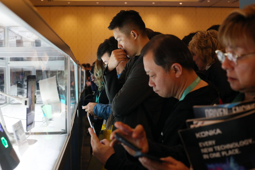 Attendees of CES 2020 look at the CES 2020 Innovation Awards at the Sands Expo on Tuesday, Jan. ...