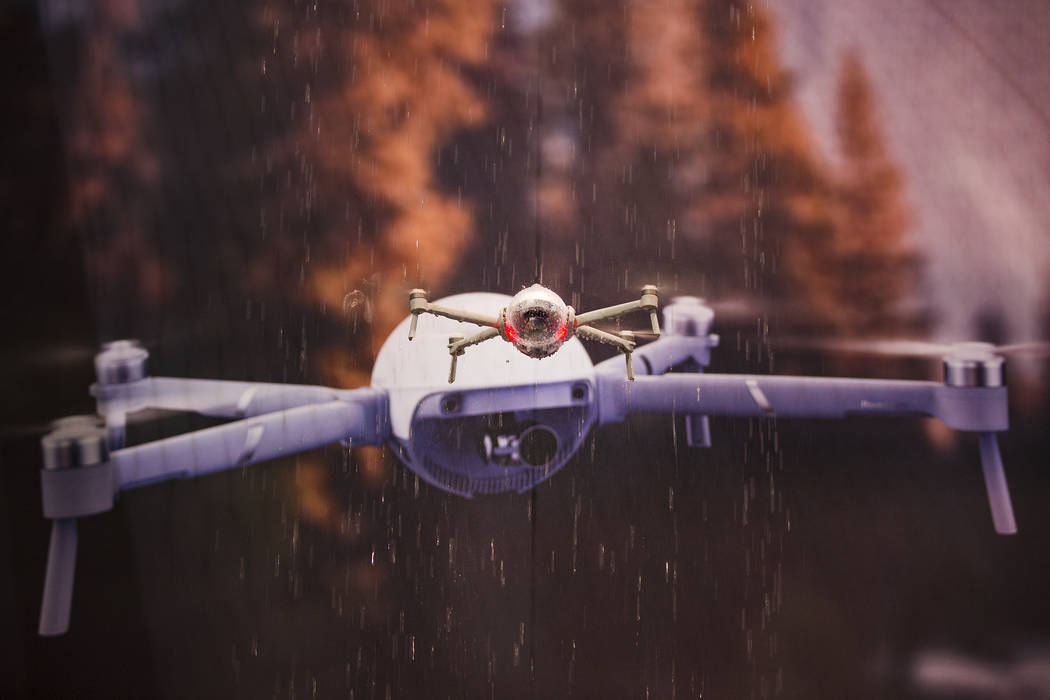 The PowerEgg X, an all weather drone created by PowerVision, flies in a waterfall at CES at the ...