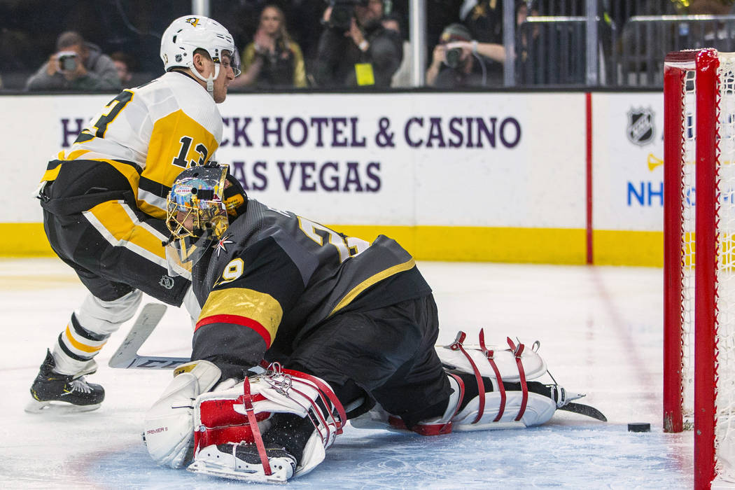 Pittsburgh Penguins' Brandon Tanev (13) scores on Vegas Golden Knights goaltender Marc-Andre Fl ...