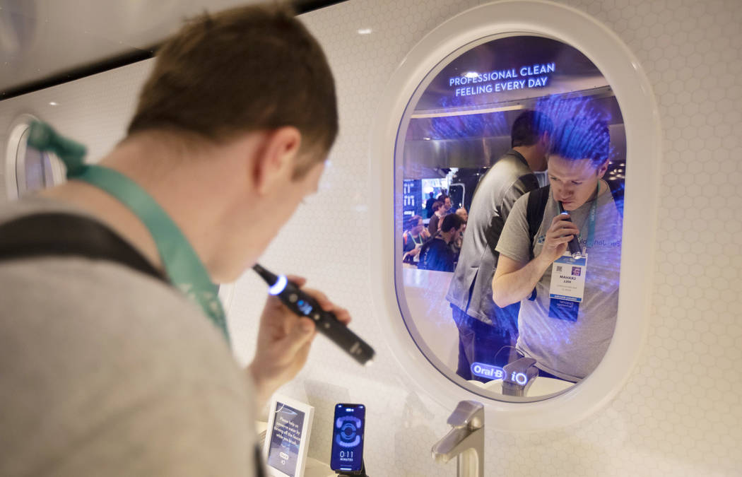 Graham Hill of Boise, Idaho brushes his teeth at the Procter & Gamble's Oral-B station on W ...