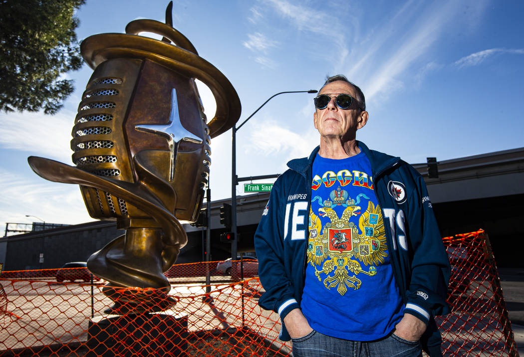 Artist Wayne Littlejohn poses with his sculpture, "Spin Baby," at the intersection of ...
