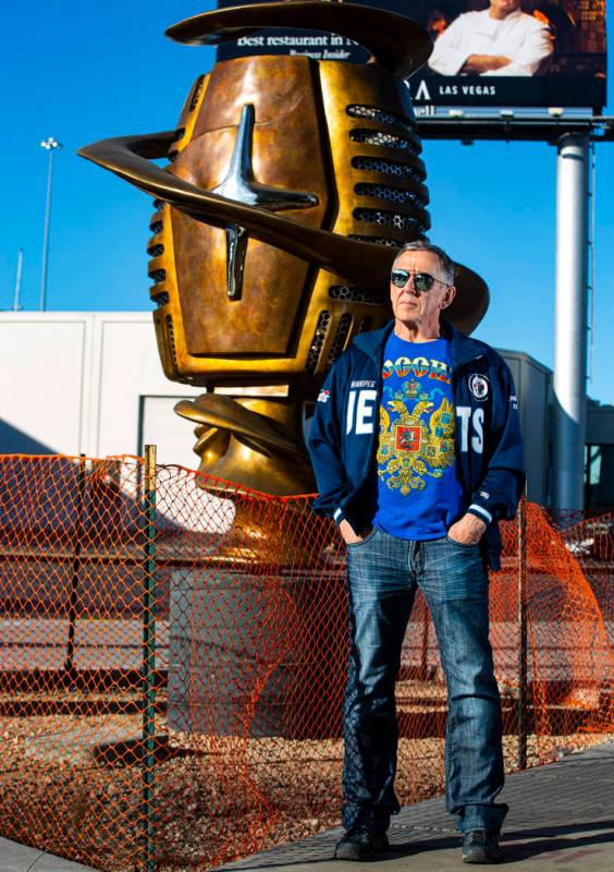 Artist Wayne Littlejohn poses with his sculpture, "Spin Baby," at the intersection of ...