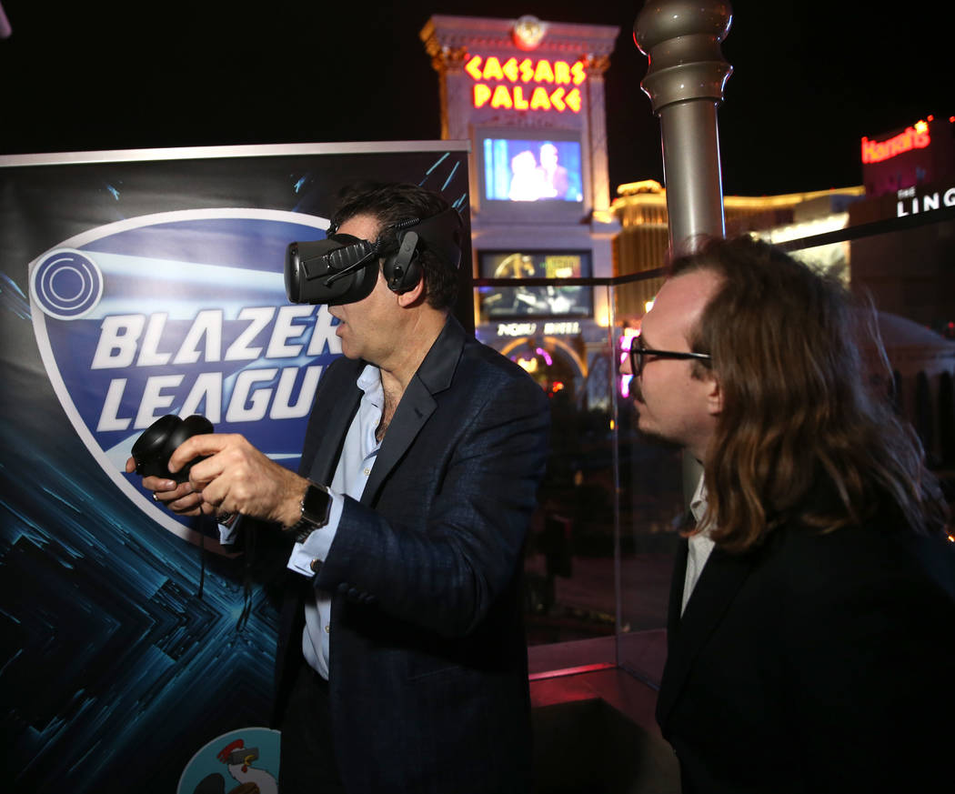 Las Vegas Review-Journal columnist John Katsilometes, left, tries virtual reality with Bryan Ch ...