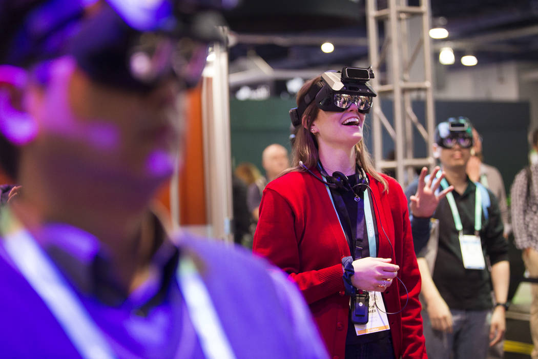 Alyson Lemmer, of Chicago, tries out Realmax virtual reality at CES at the Las Vegas Convention ...