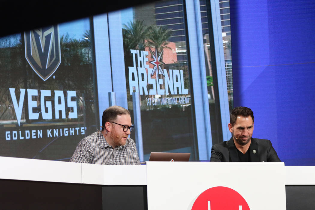 CNET host Jeff Bakalar, left, and Vegas Golden Knights TV analyst Shane Hnidy watch as they put ...