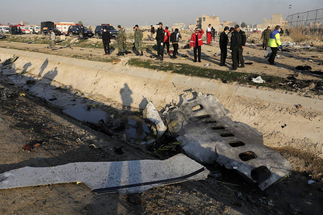 Debris is seen from an Ukrainian plane which crashed as authorities work at the scene in Shahed ...