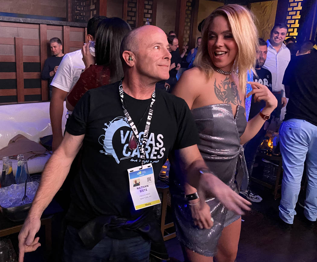 CES conventioneer Nathan Bietz of New York, dances with Stephanie Phoenix of Las Vegas during t ...