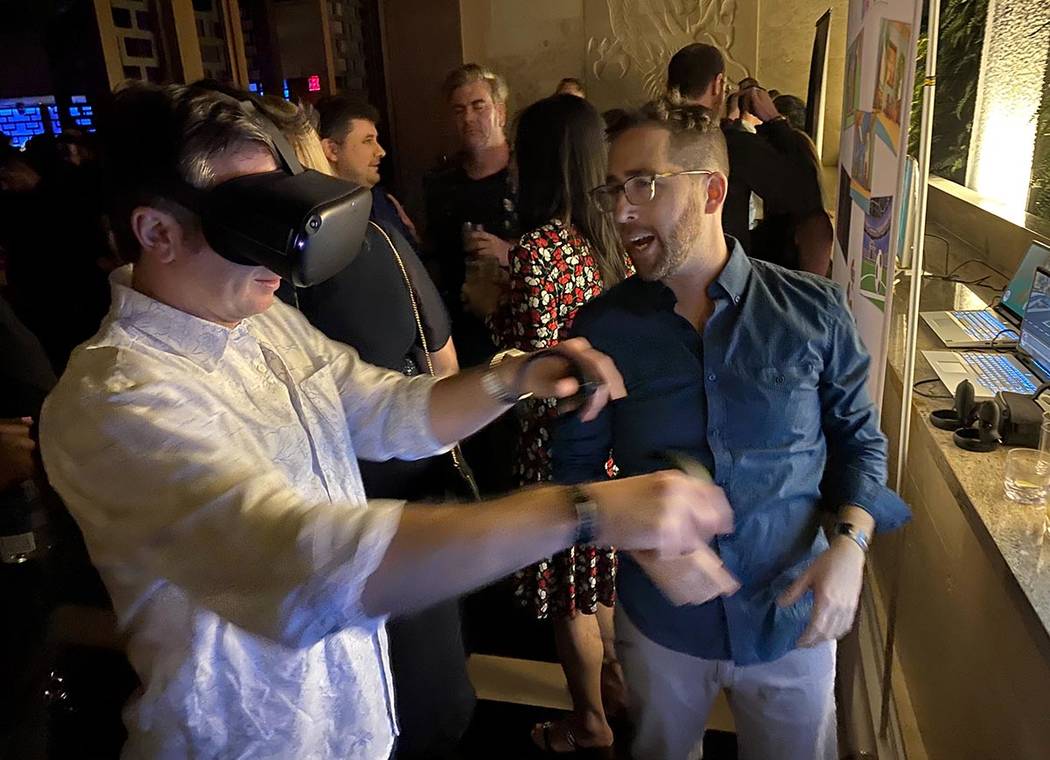 Zach Grossman of Centertec shows Jeff Rayner of Seatte a virtual reality experience during the ...