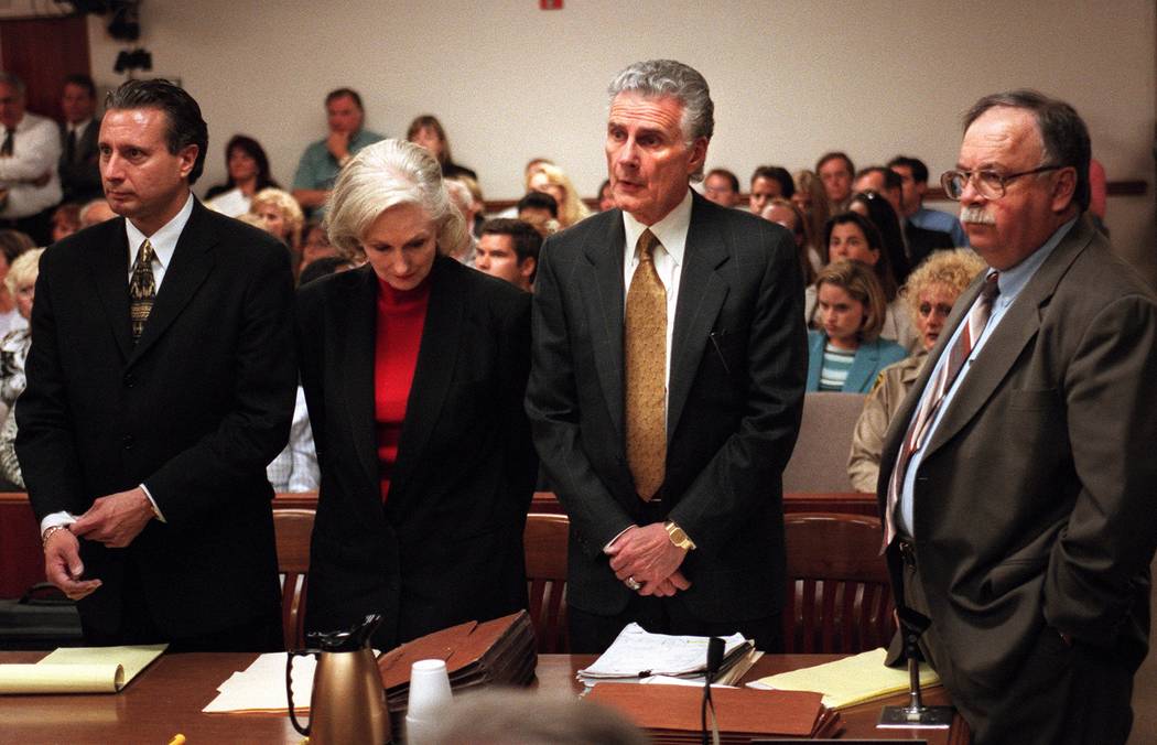 Margaret Rudin drops her head while her attorneys Michael Amador, left, John Momot and Tom Pita ...