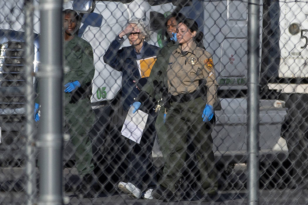 Margaret Rudin, second from left, is escorted out of Florence McClure Women's Correctional Cent ...