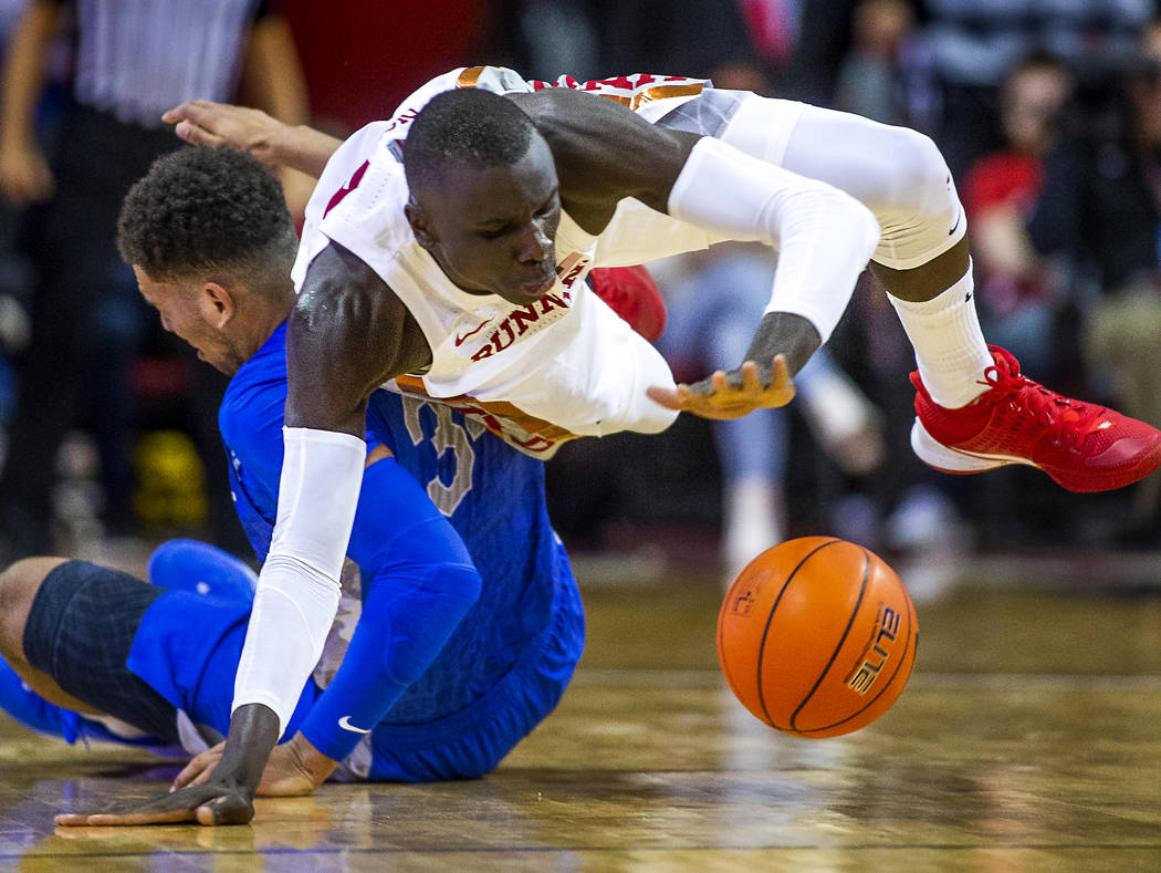 UNLV Rebels forward Cheikh Mbacke Diong (34) goes to the floor to steal the ball from Air Force ...
