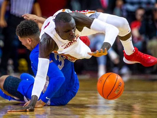 UNLV Rebels forward Cheikh Mbacke Diong (34) goes to the floor to steal the ball from Air Force ...