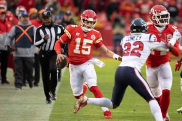 Kansas City Chiefs quarterback Patrick Mahomes scrambles for a first down during an NFL divisio ...