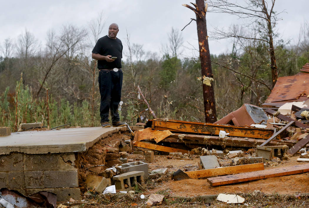 A tornado devastated homes along Settlement Road near Carrollton in Pickens County, Ala., killi ...