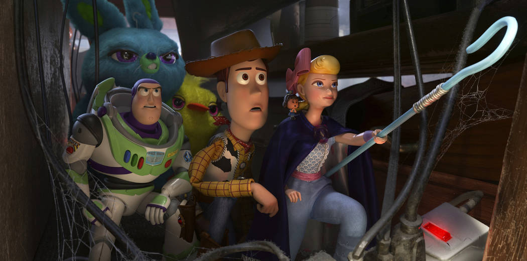 This image released by Disney shows, foreground from left, Buzz Lightyear, voiced by Tim Allen, ...