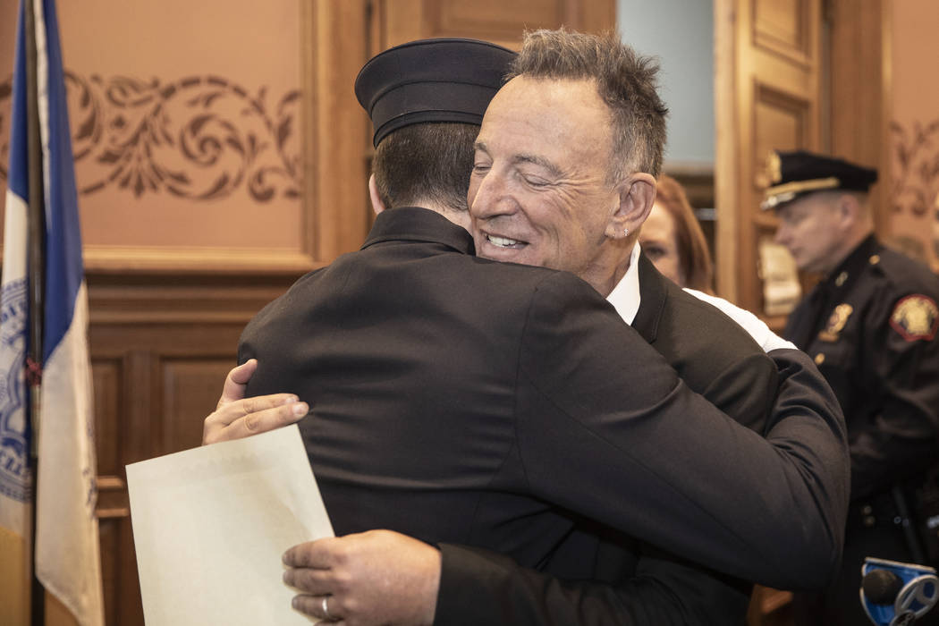 In this photo provided by the Jersey City Mayor's Office, Bruce Springsteen hugs his son Sam Sp ...