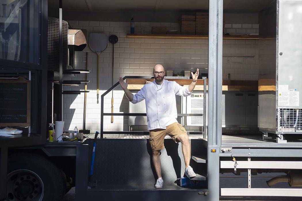 Chef Bartosz Wawrzyszak, owner of the Custom Pizza Truck, stands in his food truck parked on 31 ...