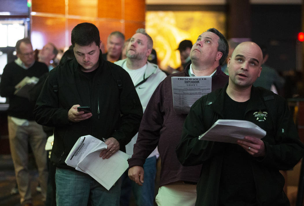 Bettors wait in line at the Westgate sportsbook on Thursday, Jan. 23, 2020, in Las Vegas. (Benj ...