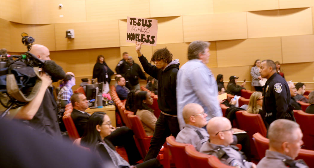 Jonathan Conlan of Las Vegas is escorted out at the start of a Las Vegas City Council meeting W ...