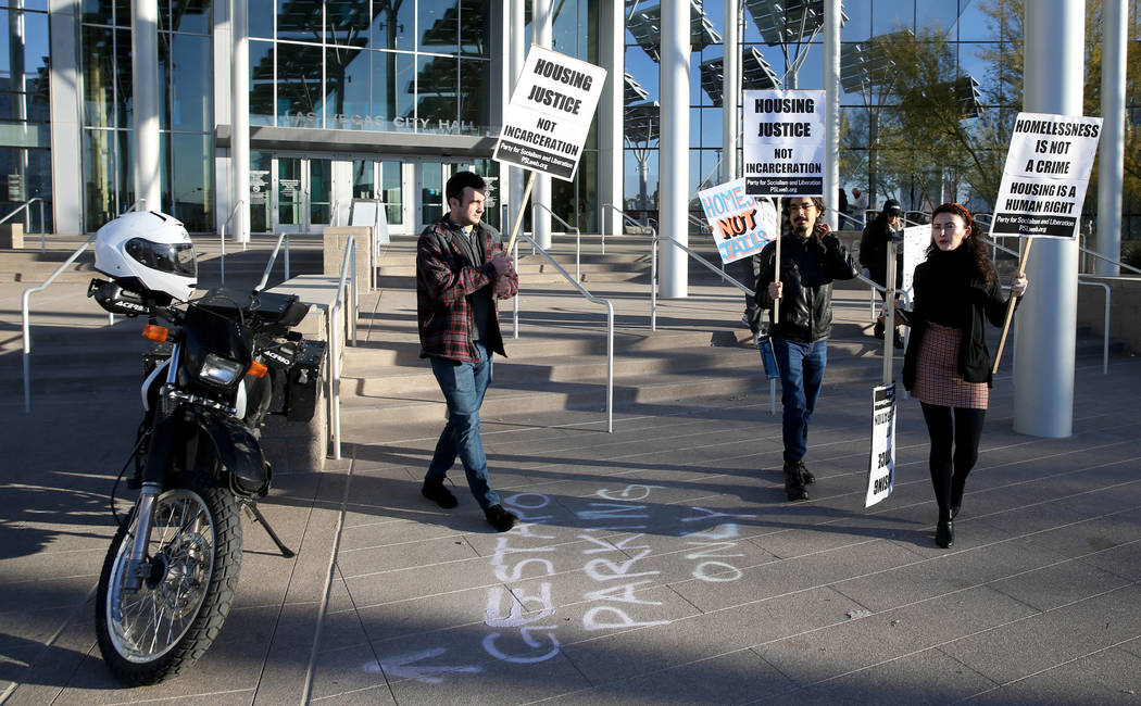 Daniel Weber, from left, Frank Lopez and Annelise Friedman, all of Las Vegas, protest before th ...