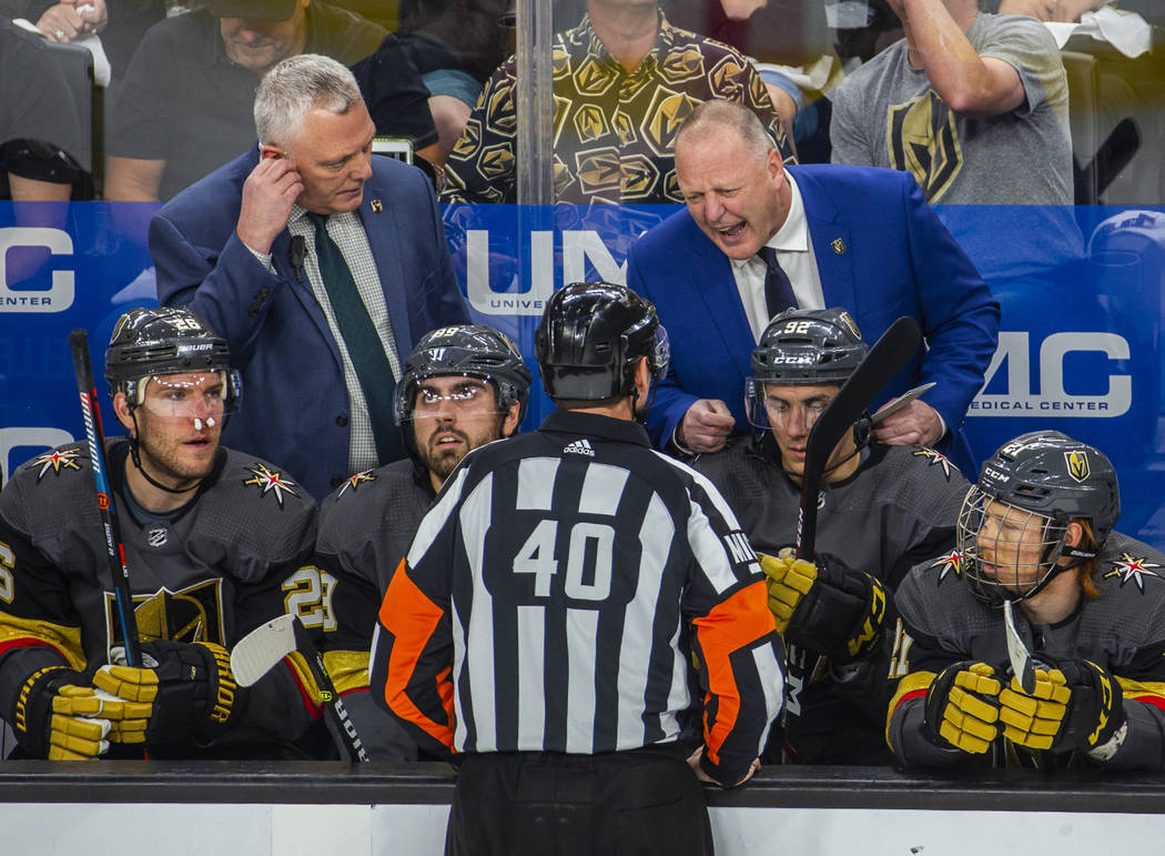Golden Knights Head Coach Gerard Gallant argues a point with a referee during the first period ...
