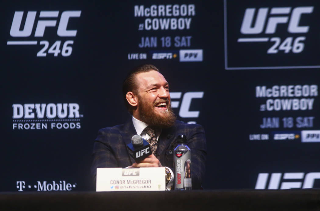 Conor McGregor reacts while talking about Donald ÒCowboyÓ Cerrone, not pictured, duri ...