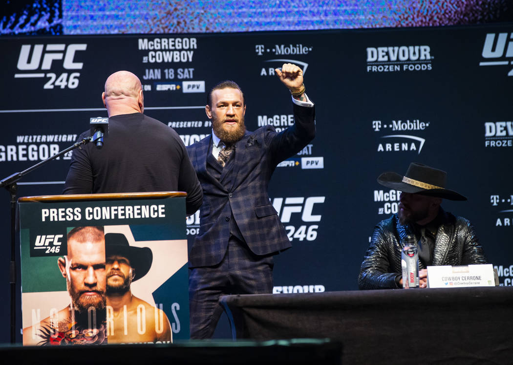 Conor McGregor, second from left, greets UFC President Dana White as he arrives for a press con ...
