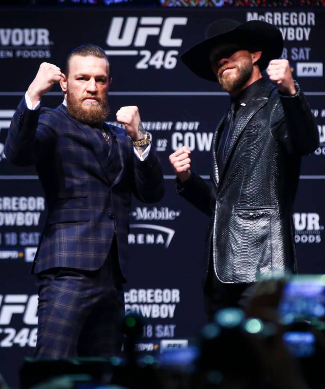 Conor McGregor, left, and Donald ÒCowboyÓ Cerrone pose for pictures during a press co ...