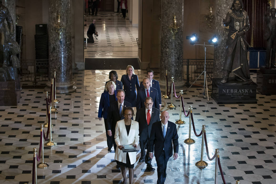 Clerk of the House Cheryl Johnson, left, and House Sergeant at Arms Paul Irving pass through St ...