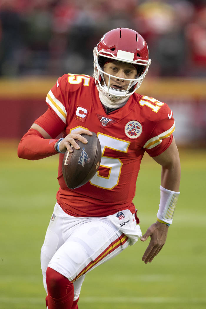 Kansas City Chiefs quarterback Patrick Mahomes scrambles for a first down during an NFL divisio ...