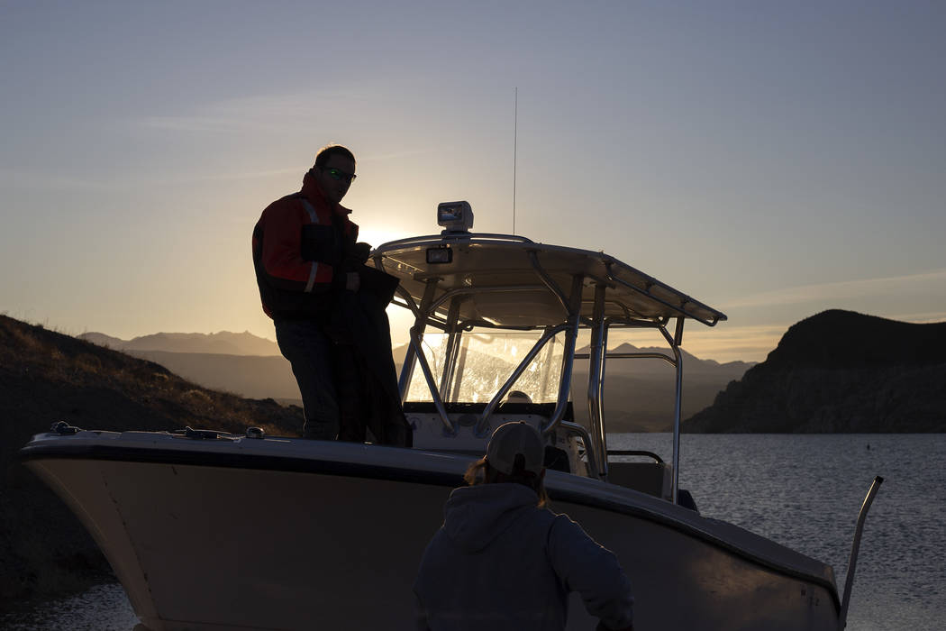 Alex Swicegood and Carrie Norman, who both work at the National Park Service, get a boat ready ...