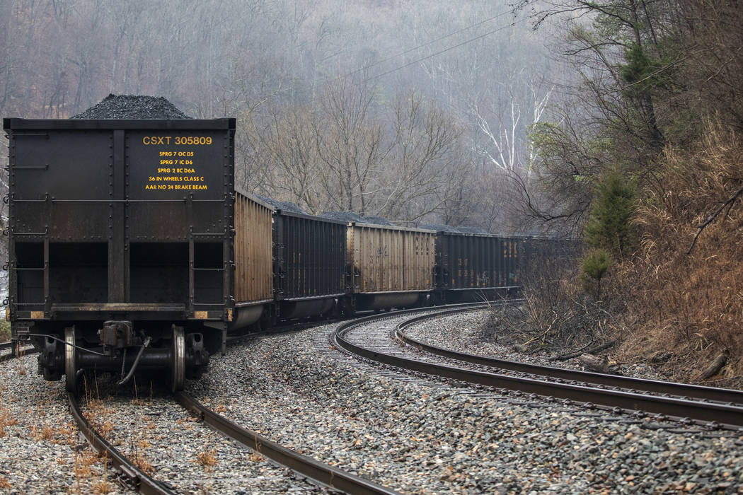 In this Tuesday, Jan. 14, 2020, photo, train cars filled with coal sit idle as miners, who say ...
