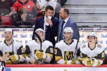 Vegas Golden Knights new head coach Peter DeBoer talks to one of his coaches on the bench as th ...