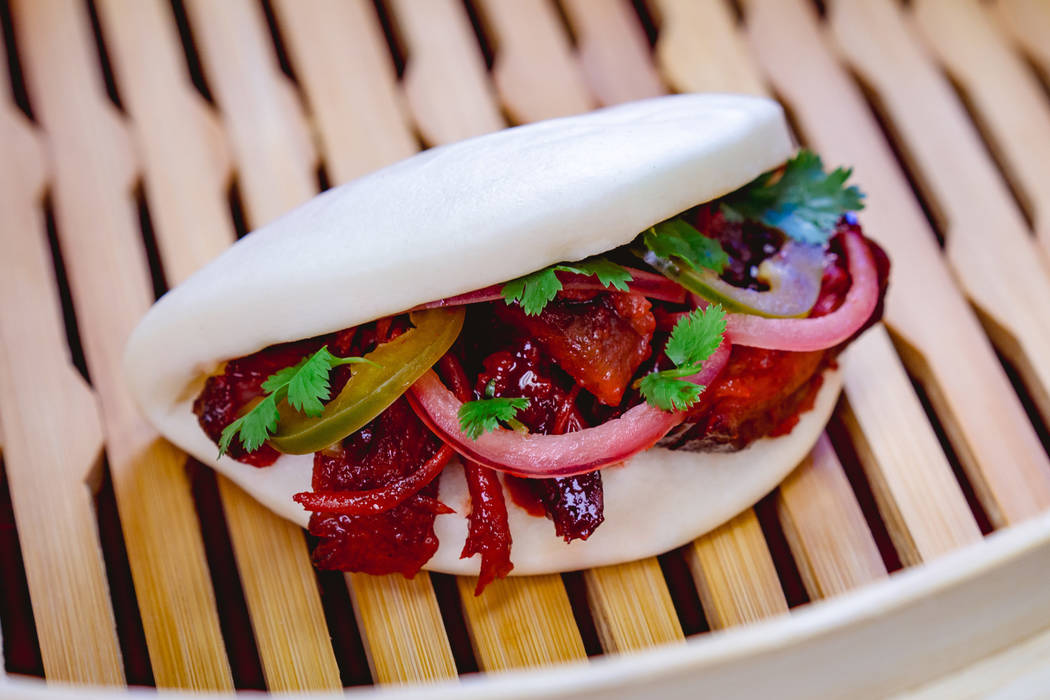 This char siu pork bao with barbecued pork, pickled red onions and jalapeño can be found a ...