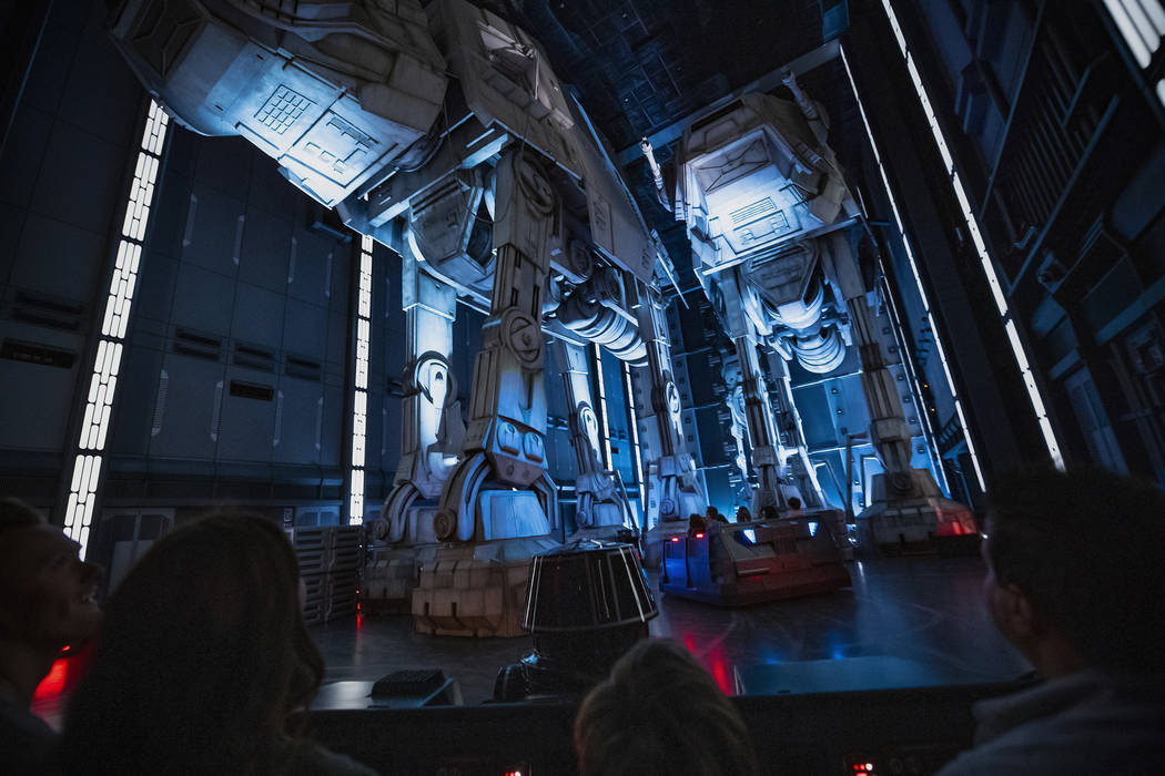 Guests race past massive AT-AT walkers aboard a First Order Star Destroyer as part of "Star War ...