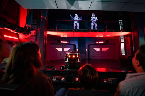 Guests flee First Order Stormtroopers onboard a Star Destroyer as part of Star Wars: Rise of th ...