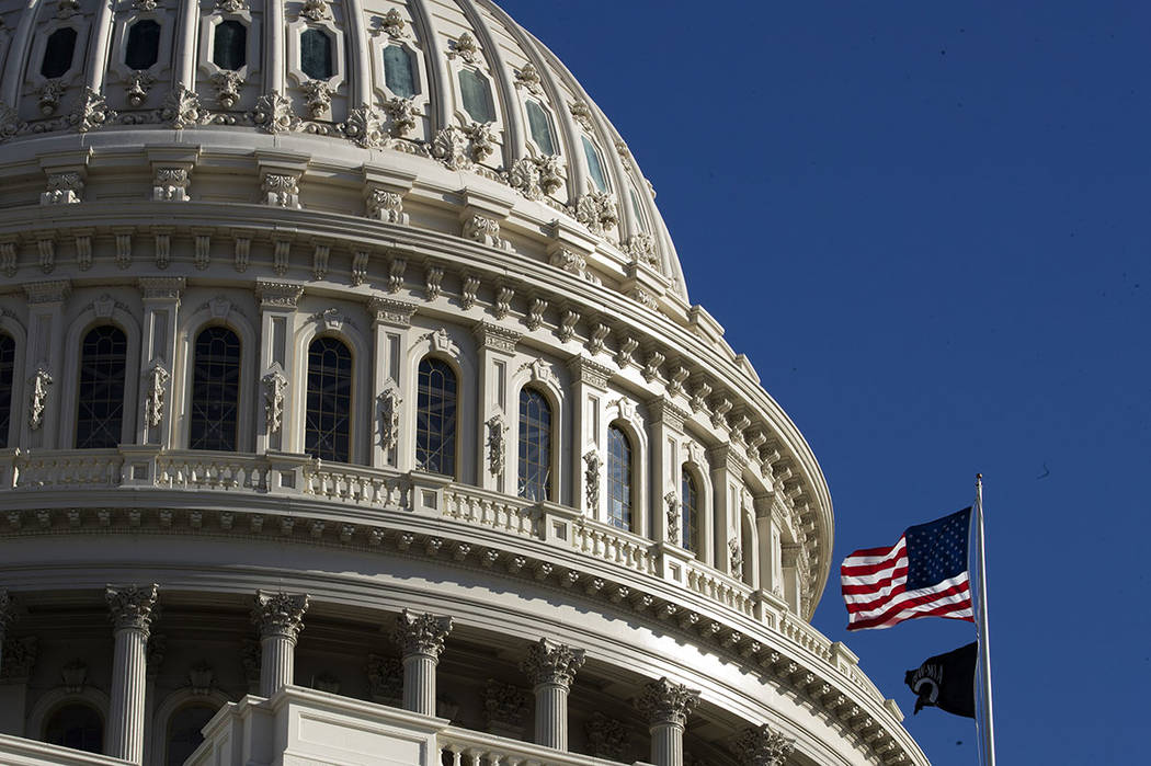 The U.S. flag flies over the U.S. Capitol in Washington, Sunday, Jan. 19, 2020. (AP Photo/Manue ...