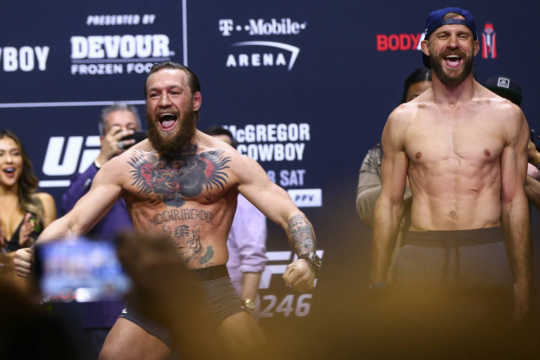 Conor McGregor, left, and Donald "Cowboy" Cerrone poses for photos ahead of their wel ...