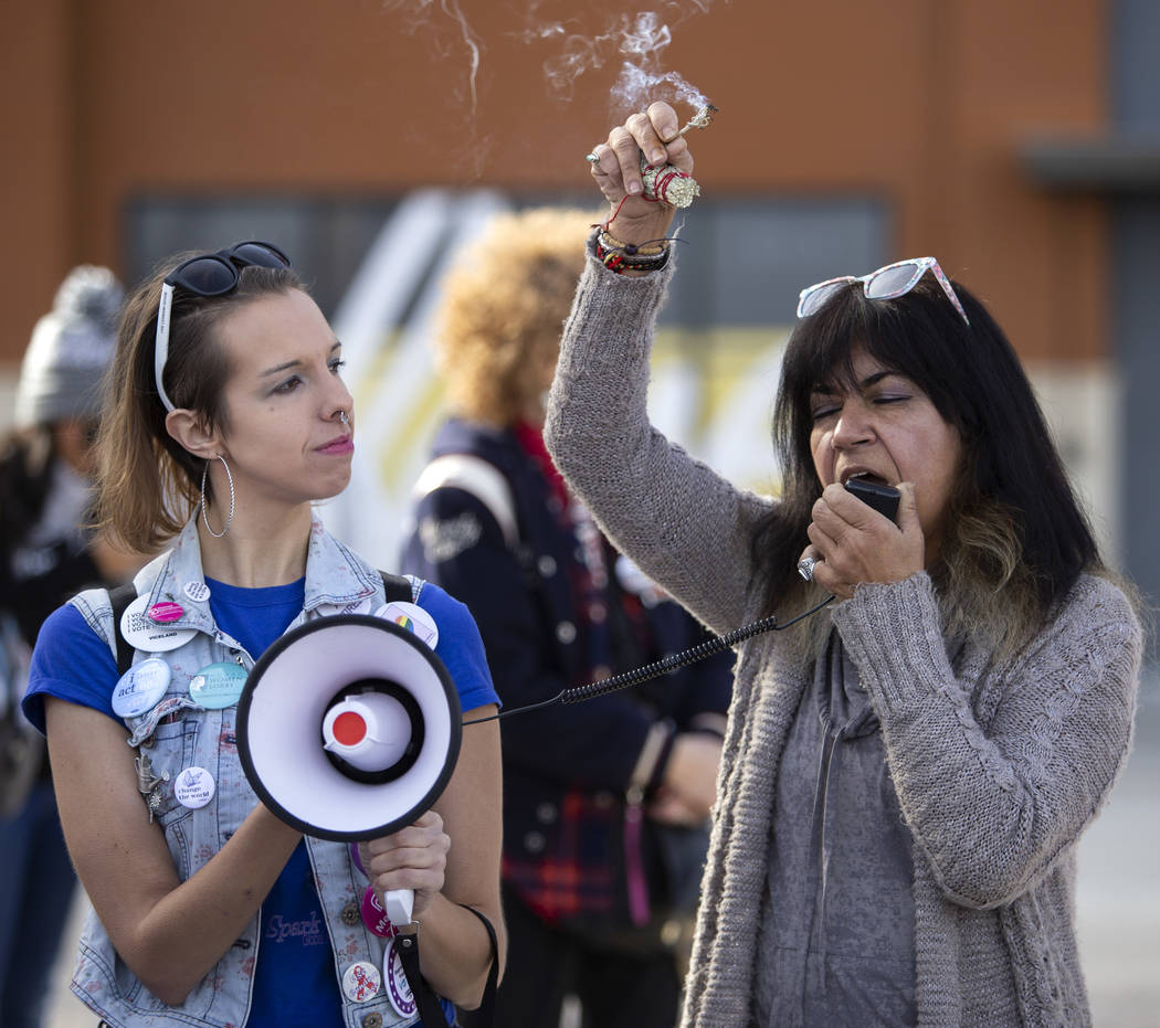 Rachel Siota, left, and Mary Lou Anderson, right, burn sage and say a prayer to begin the Empow ...