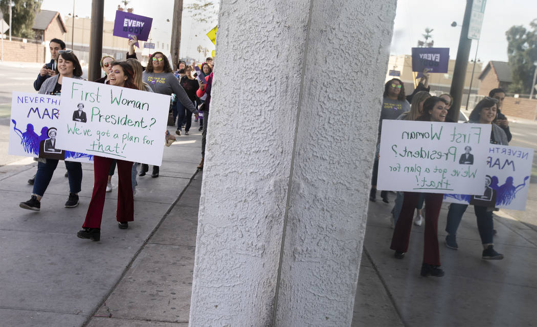 Destiny Reinoehl holds a sign supporting presidential candidate Elizabeth Warren as she marches ...