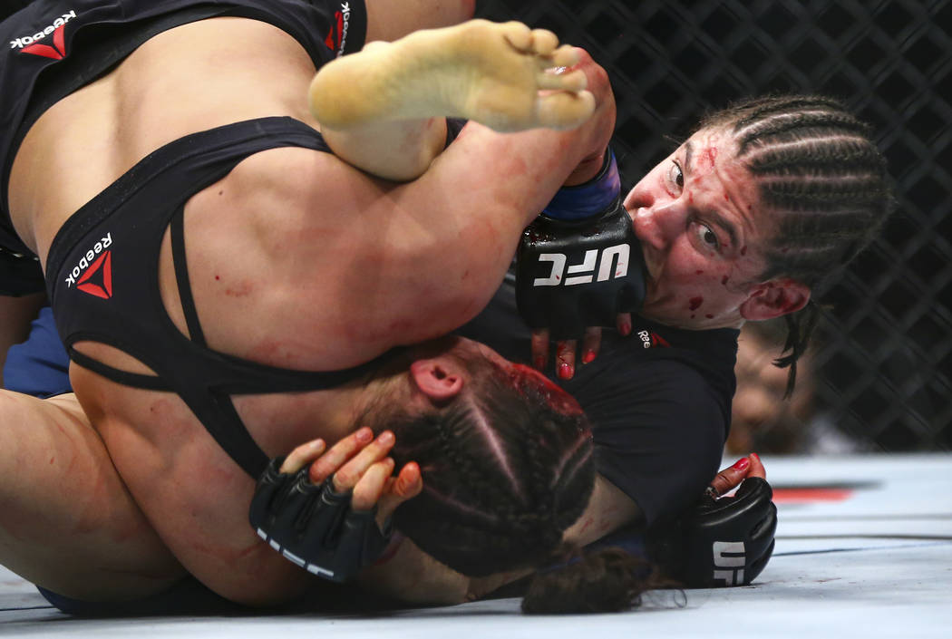 Roxanne Modafferi, right, fights Maycee Barber during their flyweight bout at UFC 246 at T-Mobi ...