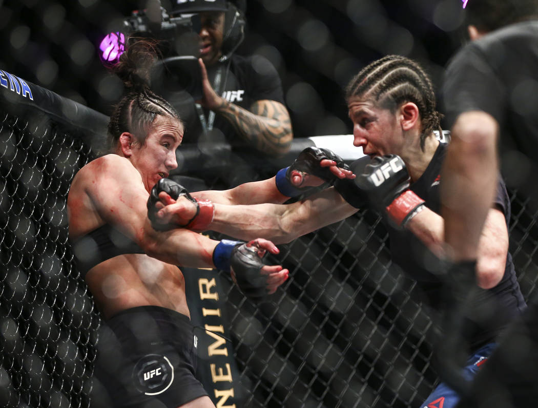 Maycee Barber, left, gets knocked to the cage by Roxanne Modafferi during their flyweight bout ...