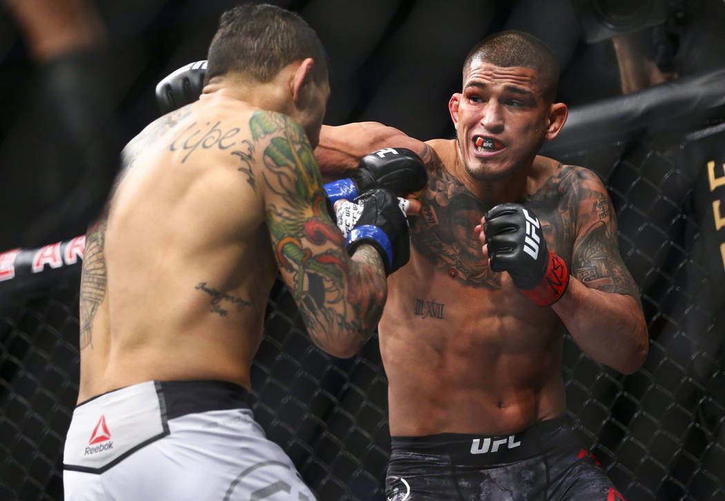 Anthony Pettis, right, fights Diego Ferreira during their lightweight bout at UFC 246 at T-Mobi ...