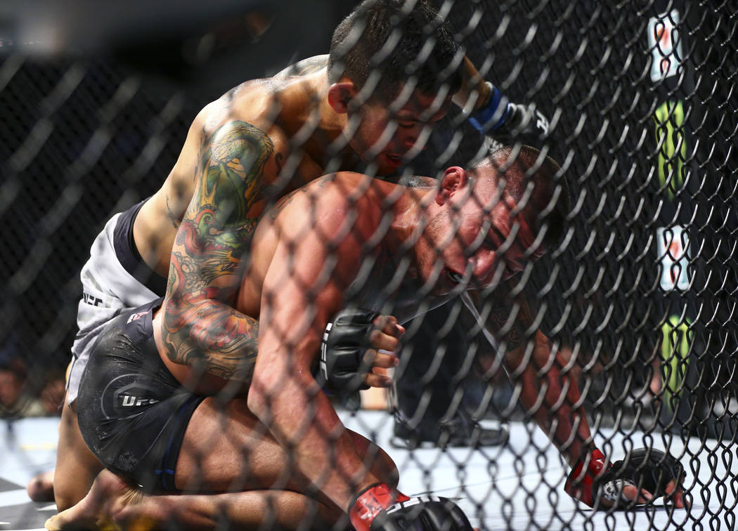Diego Ferreira, left, fights Anthony Pettis moments before defeating him via rear-naked choke d ...
