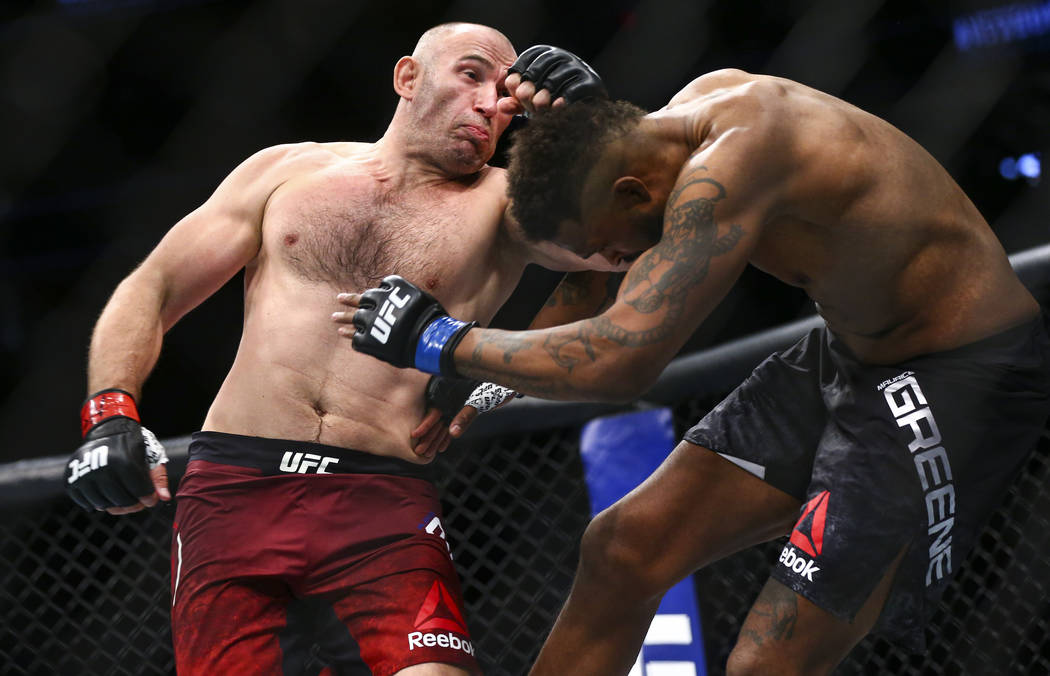 Aleksei Oleinik, left, fights Maurice Greene during their heavyweight bout at UFC 246 at T-Mobi ...