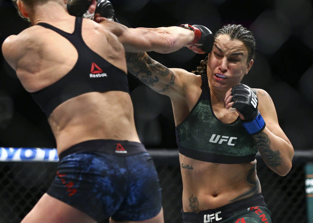 Holly Holm, left, fights Raquel Pennington during their bantamweight bout at UFC 246 at T-Mobil ...