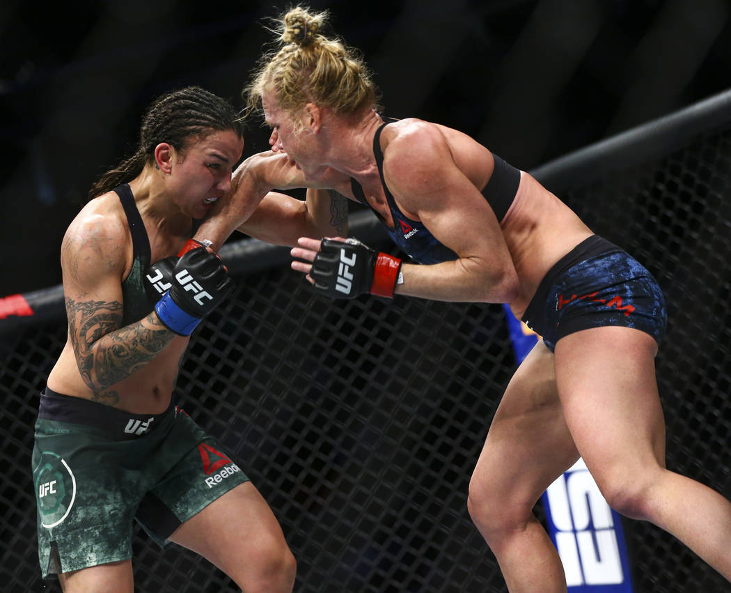 Raquel Pennington, left, fights Holly Holm during their bantamweight bout at UFC 246 at T-Mobil ...
