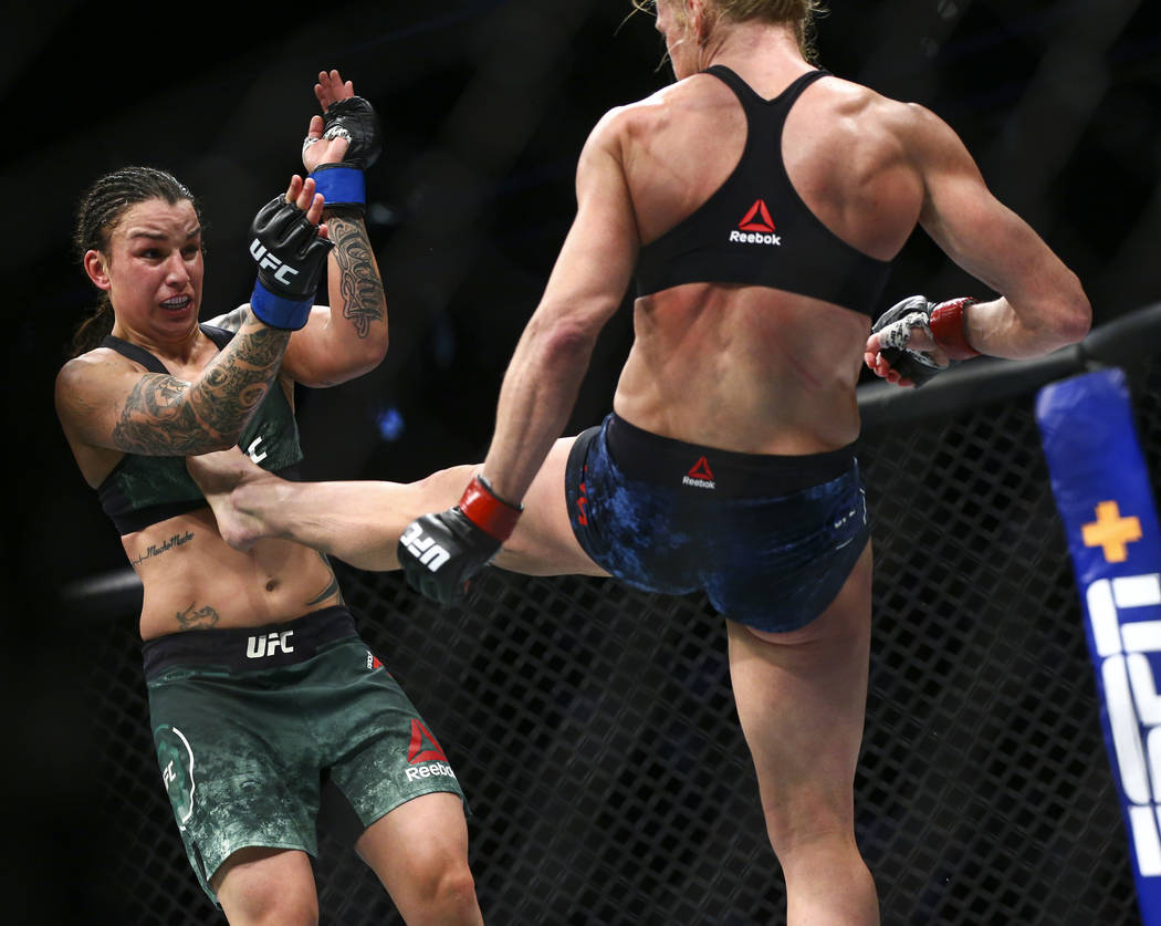Raquel Pennington, left, fights Holly Holm during their bantamweight bout at UFC 246 at T-Mobil ...