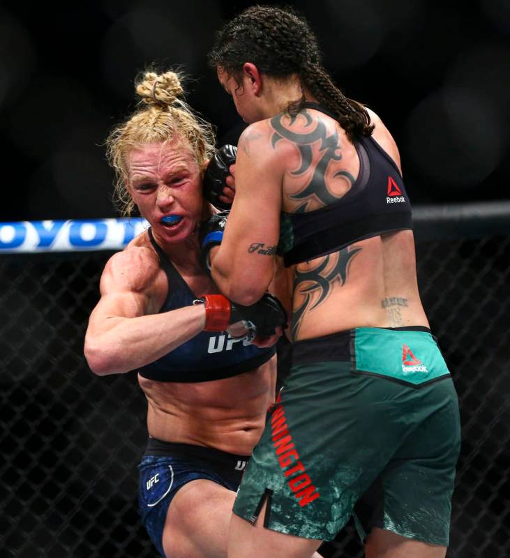 Holly Holm, left, fights Raquel Pennington during their bantamweight bout at UFC 246 at T-Mobil ...