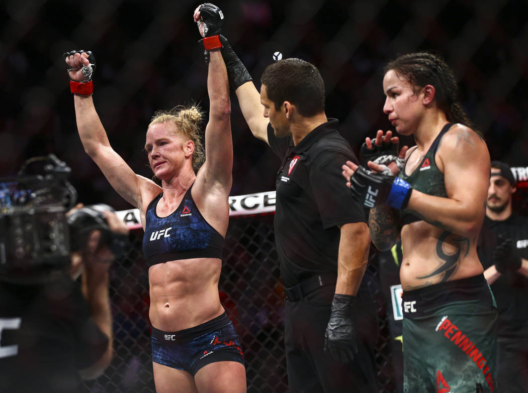 Holly Holm celebrates her unanimous decision victory over Raquel Pennington in their bantamweig ...